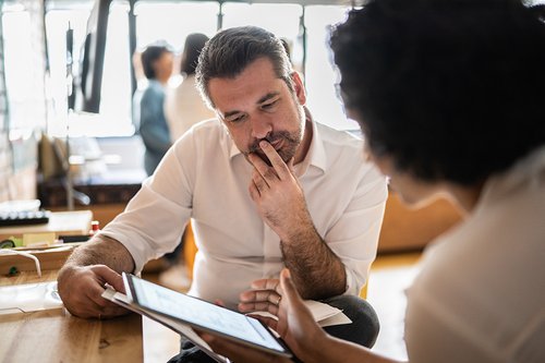 A solutions manager sits with a client 