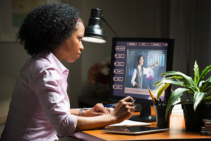 Student at desk computer looking at eLearning lesson on screen