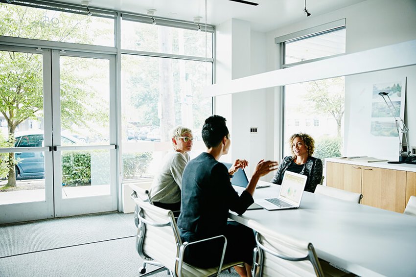 people in office around table talking people in office around table talking